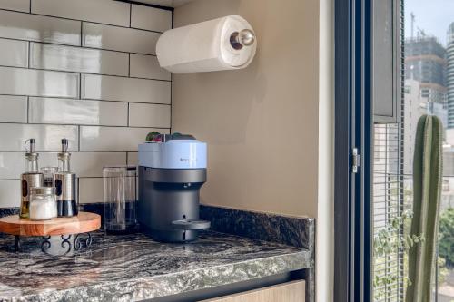 a kitchen counter with a coffee maker on a counter top at Myla Chapultepec in Mexico City