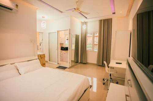 a hospital room with a bed and a desk at White Lotus Homestay in Dibrugarh