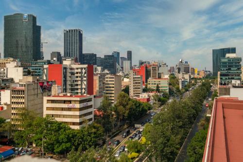 a view of a city with buildings and cars at Myla Chapultepec in Mexico City
