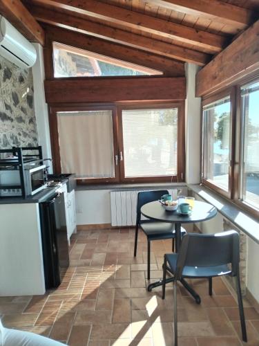 a kitchen with a table and chairs in a room at Villa Marini in Trevignano Romano