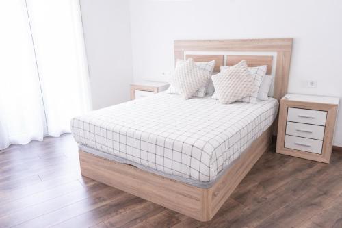 a bedroom with a large bed with a white mattress at Apartamento Cassa de la selva in Cassà de la Selva