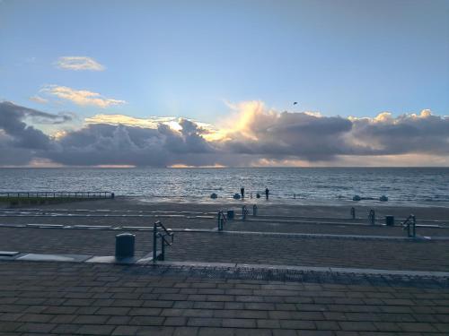 a view of a beach with people on the water at Pension Zur Brandung in Büsum