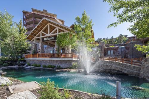 a fountain in a pool in front of a building at Condos at Canyons Resort by White Pines in Park City