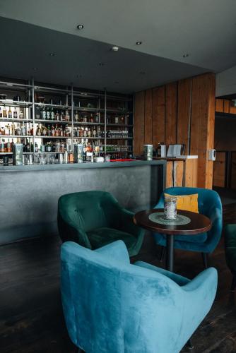 a room with two chairs and a table and a bar at Hotel Laki in Kirkjubæjarklaustur