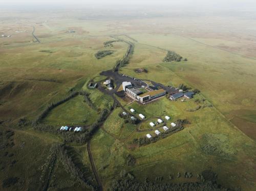 an aerial view of a house in the middle of a field at Hotel Laki in Kirkjubæjarklaustur
