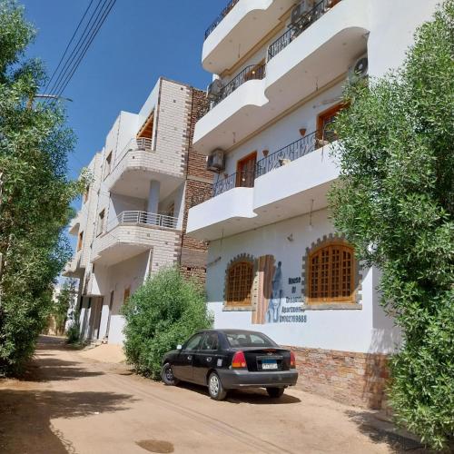 a car parked in front of a building at House of Dreams apartments Luxor in Luxor