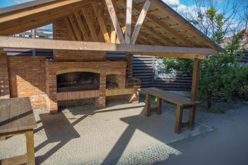 a patio with a brick fireplace and a bench at Fazenda in Sumy