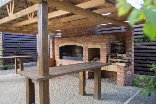 a wooden bench sitting in front of a brick oven at Fazenda in Sumy