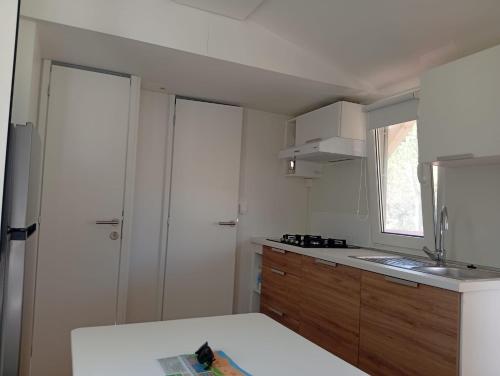 a kitchen with a sink and a counter top at Casetta sul mare in Lido di Classe