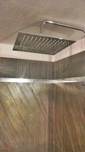 a shower with a shower head in a bathroom at Home in Garfagnana in Vagli di Sotto