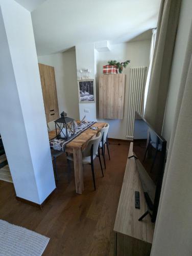 a dining room with a wooden table and chairs at Maison Poluc - Chiaro di Luna in Champoluc