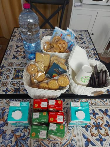 a table with a basket of food and a bottle of water at B&B Piazza Mazzini in Catania