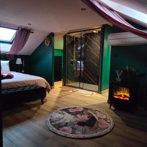 a bedroom with a bed and a fire place at La Bulle de Velours in Bouguenais