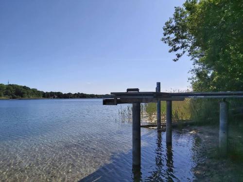 a dock in the middle of a body of water at Appartement für 4 Personen in Strausberg in Strausberg