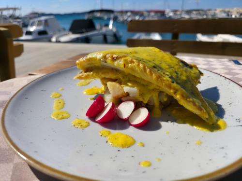 a plate of food on a table with food on it at Hotel Marina in Fažana