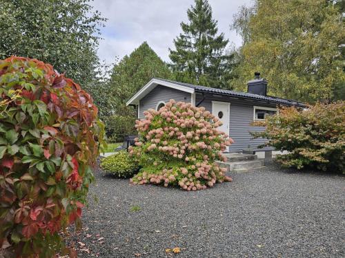 a house with a bush of flowers in front of it at 4 person holiday home in LÖDDEKÖPINGE in Löddeköpinge