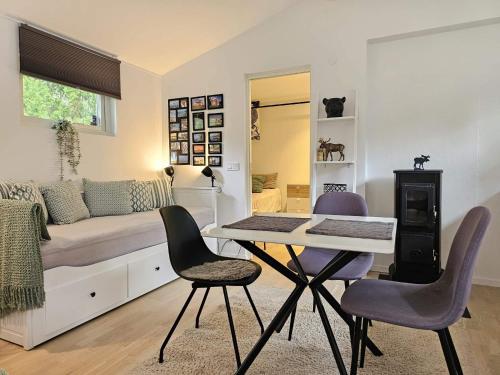 a bedroom with a bed and a table and chairs at 4 star holiday home in Löddeköpinge in Löddeköpinge