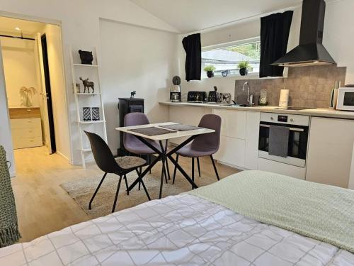 a kitchen with a table and chairs in a room at 4 star holiday home in Löddeköpinge in Löddeköpinge