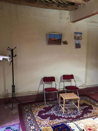 a room with two chairs and a table and a tripod at GITE LA GROTTE VALLEE in Aoûtouss