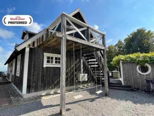 a small wooden building with a staircase in it at 4 star holiday home in Drottningskär in Drottningskär