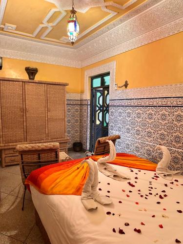 a bedroom with a large bed with confederate at Riad Tasneem in Marrakech
