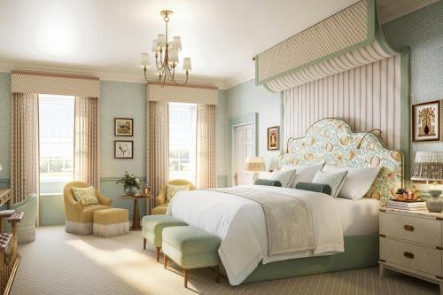 a bedroom with a large white bed and a chair at Mount Juliet Estate, Autograph Collection in Thomastown