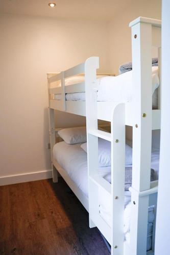 a room with two bunk beds in a room at Kingfisher in Pembrokeshire
