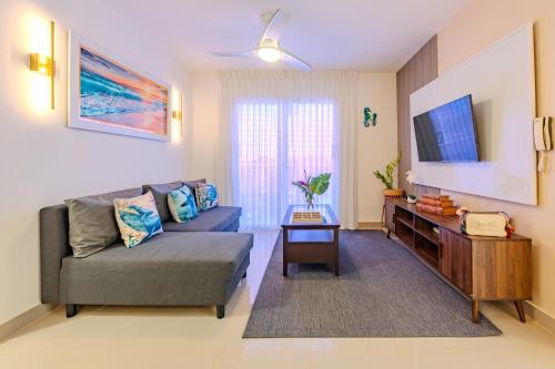 a living room with a couch and a tv at Oasis cerca del mar #2 in Monte Adentro