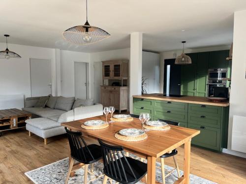 a kitchen and living room with a wooden table at Maison 3 chambres in Changé