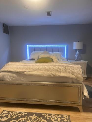 a bed with a blue headboard in a bedroom at Spacious Family-friendly Apartment in New Haven