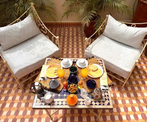 a table with a tray of food on top of a table at Riad Tasneem in Marrakech