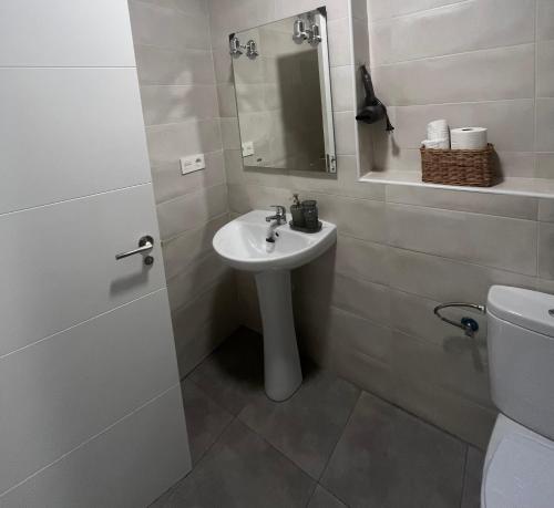 a white bathroom with a sink and a toilet at El Rincón de Agua Amarga 2 in Agua Amarga
