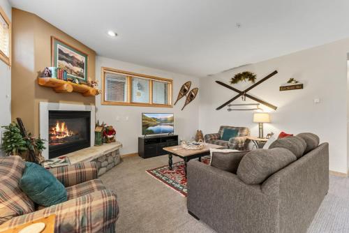 a living room with two couches and a fireplace at Cozy Breck Condo - Walk to Main St & Lifts - Hot Tub in Breckenridge
