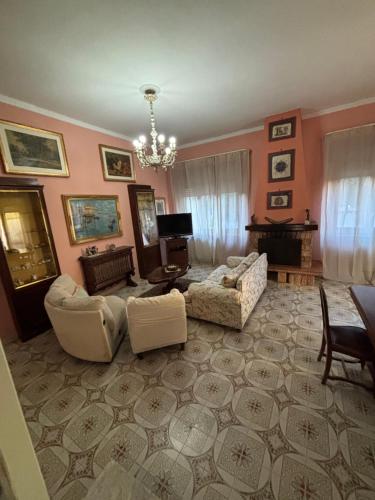a living room with a couch and chairs at Tabor 1 garden & parking in Naples