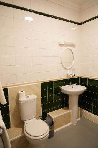 a bathroom with a toilet and a sink at The Continental Hotel, Derby in Derby