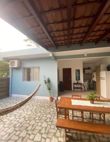 a patio with a hammock in a house at Cantinho da amizade in Florianópolis