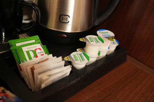 a counter with a bunch of toothbrushes and some food at The Continental Hotel, Derby in Derby