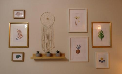 a wall with pictures of plants on it at Don Chu's Hideout in Toa Alta