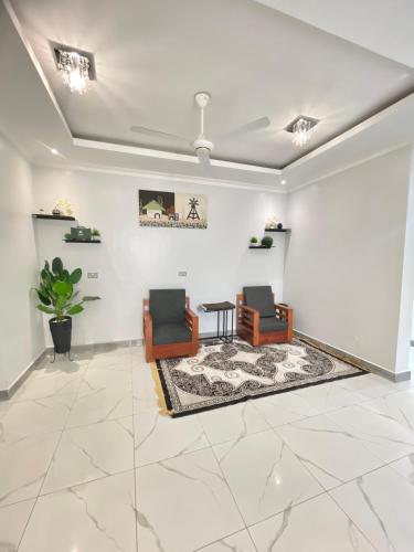 a living room with two chairs and a table at HalmaHome in Chukwani