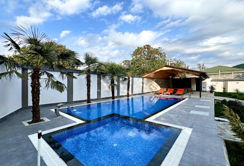 a swimming pool on the roof of a house at Qafqaz Palm A-Frame Retreat in Gabala