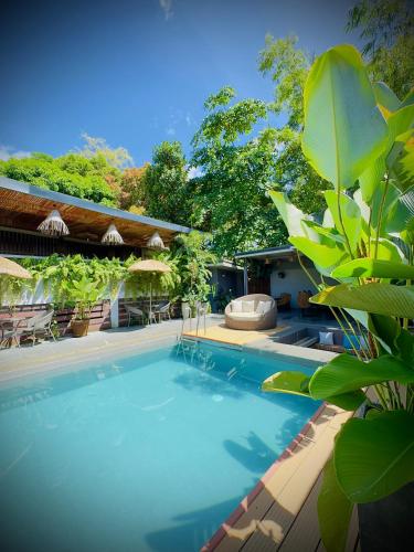 a swimming pool in front of a house at Villa Marii in Dipolog