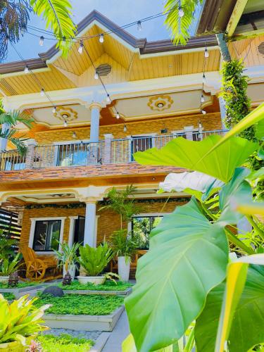 a house with a lot of plants in front of it at Villa Marii in Dipolog