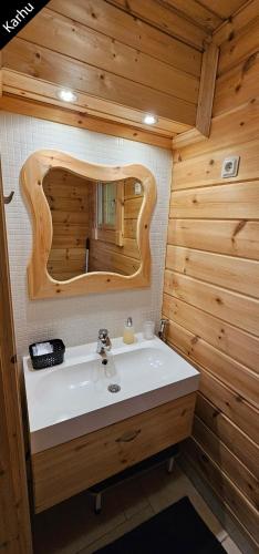 a bathroom with a sink and a mirror at Quiet Lakeside Forest Escape in Imatra