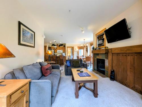 a living room with a couch and a tv at Springs 8803 by SummitCove Lodging in Colorado in Keystone