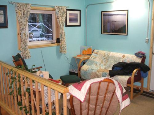 a living room with a couch and a crib at Cook's Place in Tok