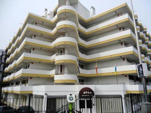 a tall white building with an aico sign in front of it at 7 building Aloe - Lovely Apartment, Wifi gratis Central near dunes G in Maspalomas