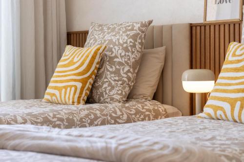 a bed with pillows on top of it at Fun and Sun - Appartement de luxe - Dahomey Beach - Bouznika in Bouznika