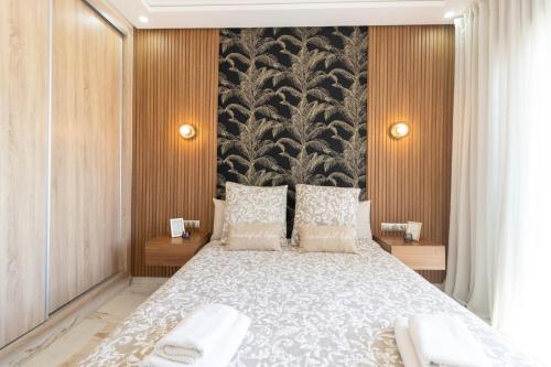 a bedroom with a large bed and a large wall at Fun and Sun - Appartement de luxe - Dahomey Beach - Bouznika in Bouznika