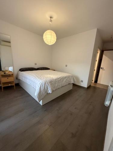 a bedroom with a bed and a pendant light at Petit House Madrid Chinatown in Madrid