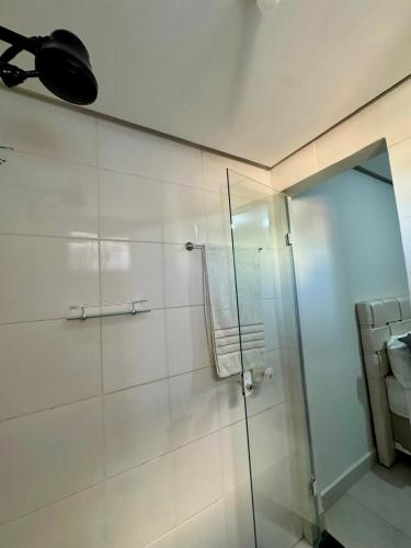 a bathroom with a shower with a glass door at Residencial Leste Universitário in Goiânia